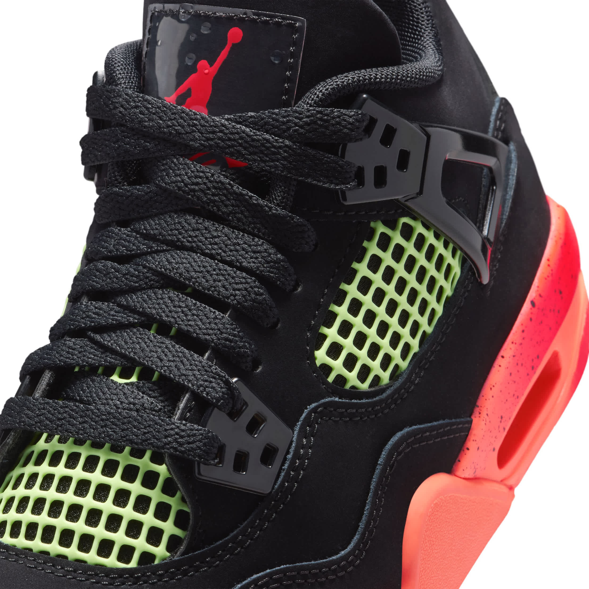 Black sneaker with red and green accents on a white background