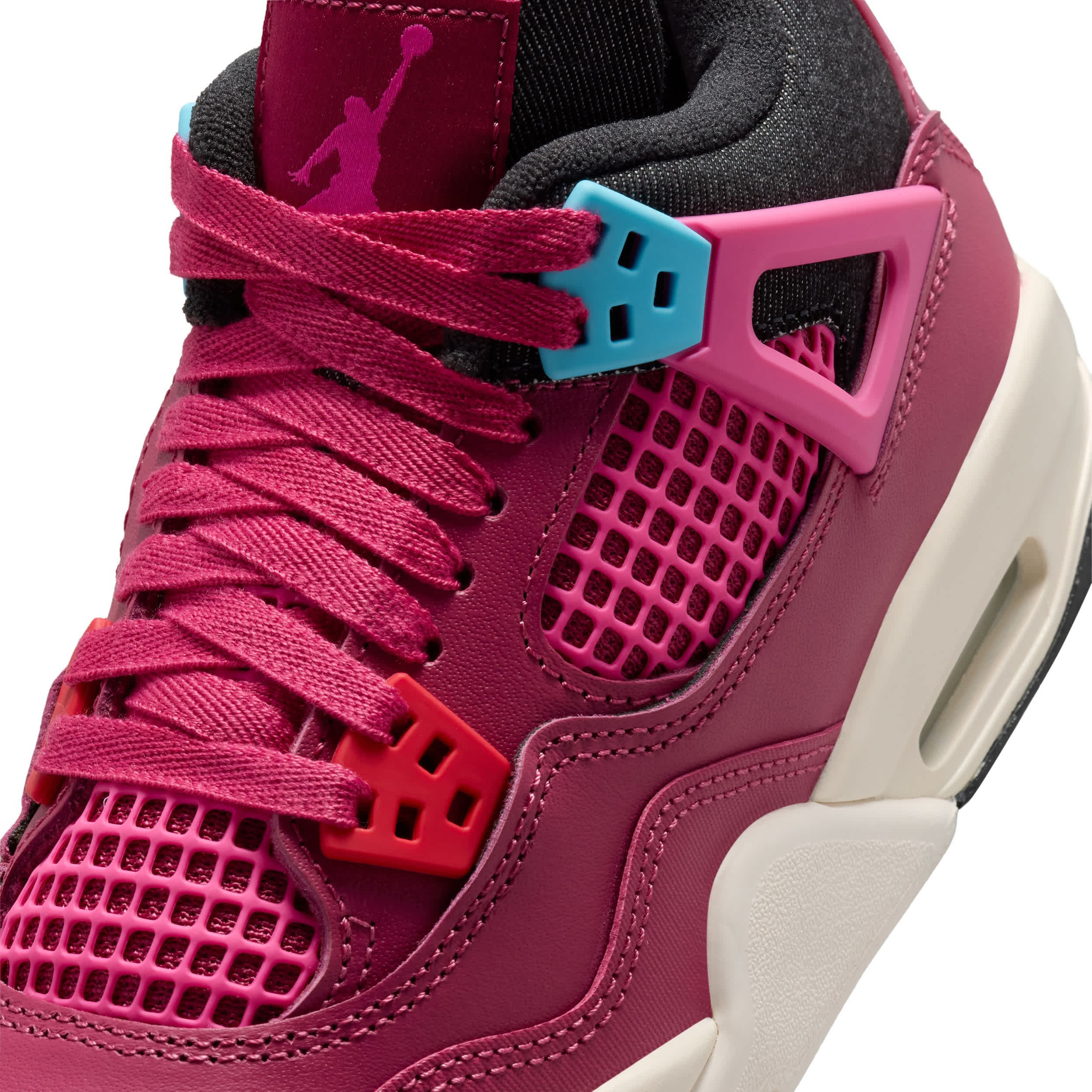 Close-up of a pink sneaker with a unique sole design on a white background